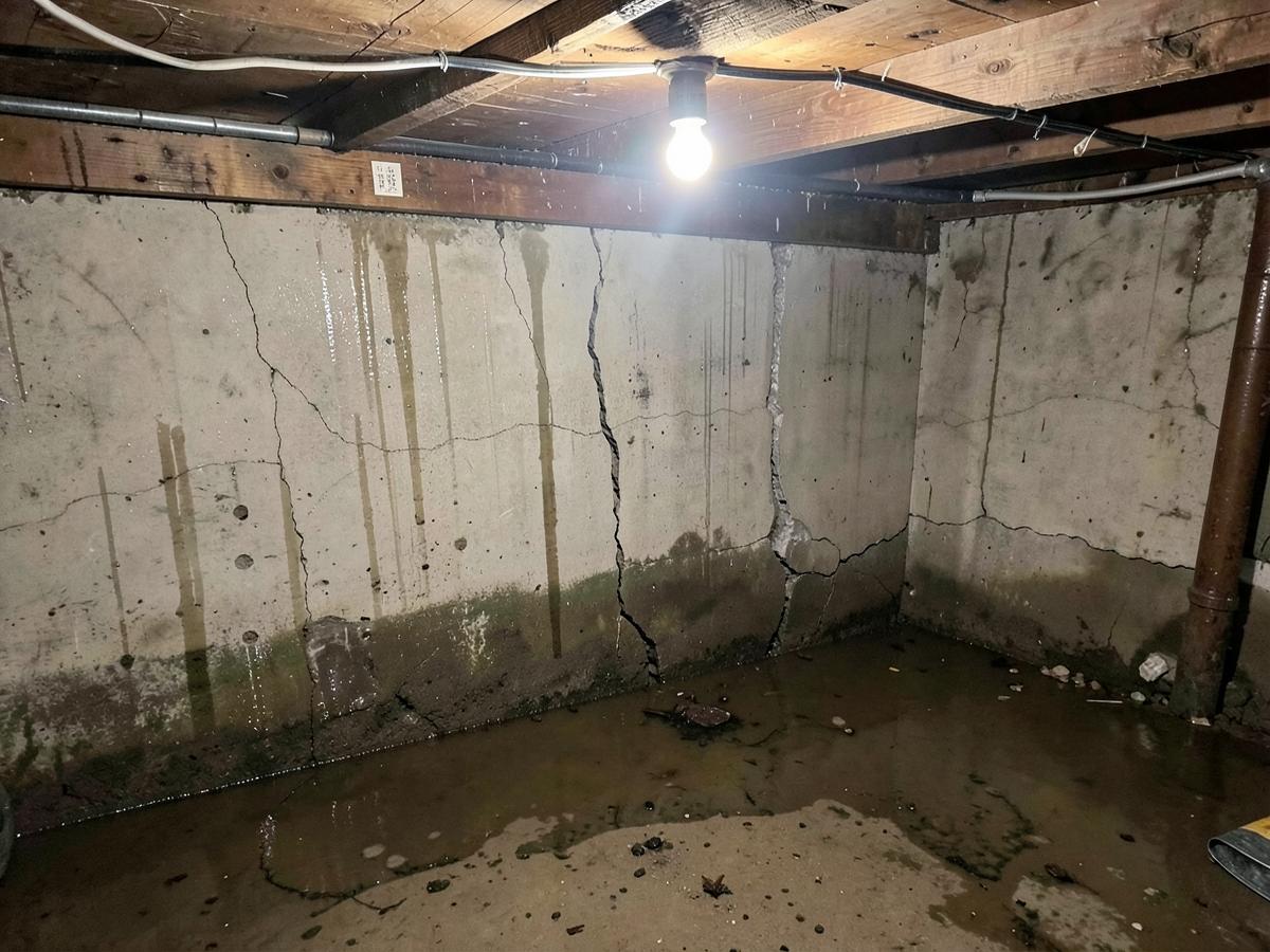Wet Basement Sealed & Drained — before